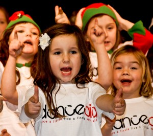 School children performing at a show for danceaid