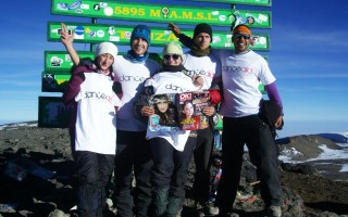 Team of danceaid supporters at the top of Mount Kilimanjaro