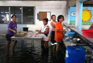 The volunteers battle through the flooding to feed the street children